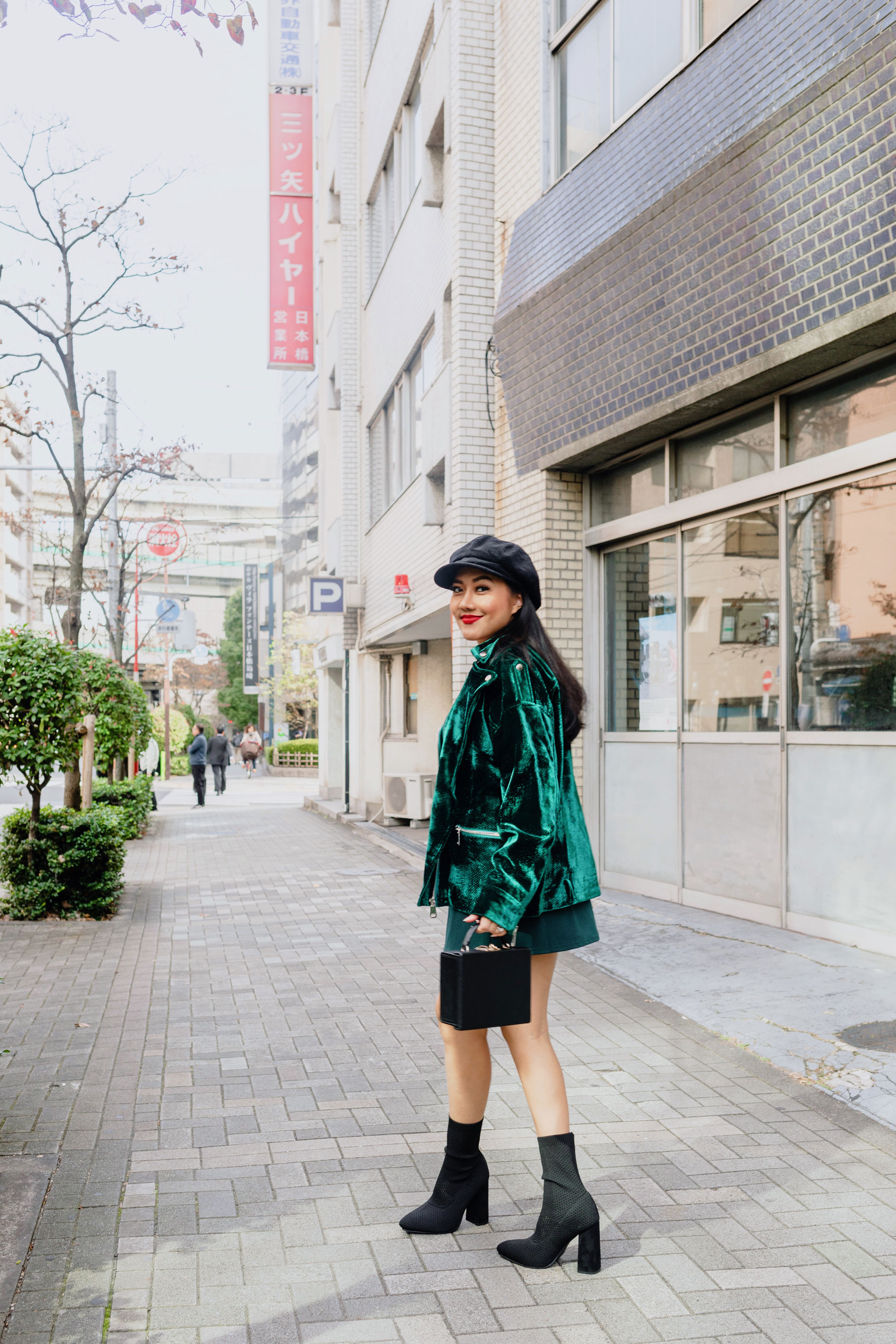 Molly larsen lifestyle blogger wearing a green dress and green jacket in Tokyo Japan while holding a black bag and wearing black shoes Green Dress, Emerald Green Dress